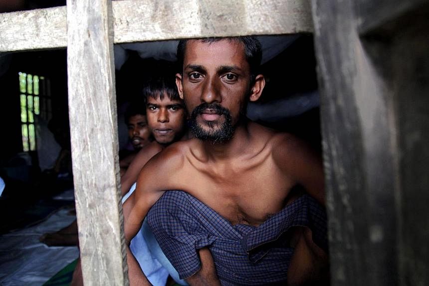 Rohingya Muslims from Bangladesh rescued by the Myanmar navy sit inside buildings at a temorary refugee camp in the village of Aletankyaw in the Maungdaw township of northern Rakhine state, Myanmar on May 23, 2015. Bangladesh on Wednesday, May 27, sa