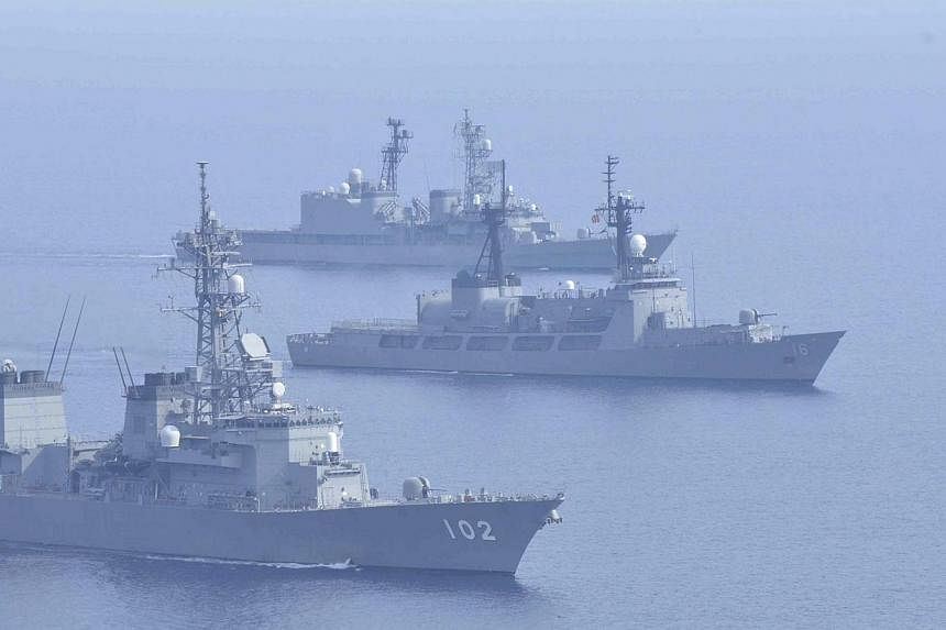 Japanese Maritime Self-Defence Force destroyers Harusame (bottom) and Amagiri (top) sail side by side with Philippine warship BRP Ramon Alcaraz during a joint naval drill in the South China Sea on May 12, 2015. The two nations are set to bolster secu