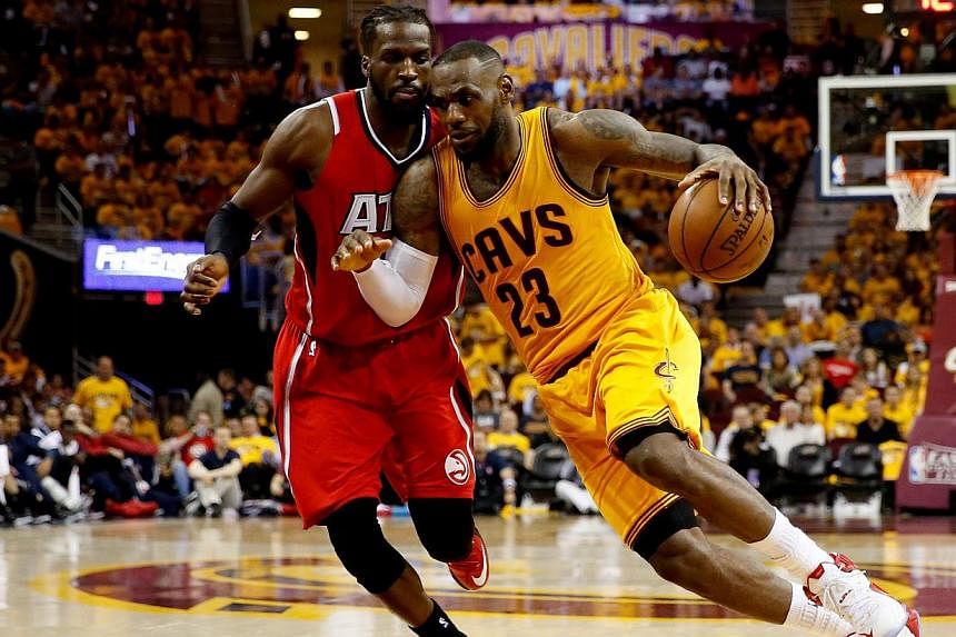 LeBron James (right) of the Cleveland Cavaliers drives with the ball against DeMarre Carroll (left) of the Atlanta Hawks in the third quarter during Game Four of the Eastern Conference Finals of the 2015 NBA Playoffs at Quicken Loans Arena on May 26,