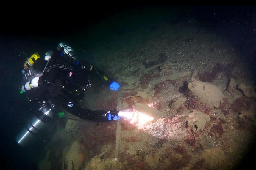 An undated handout picture released by Russia's Rostov Dive divers club shows a diver observing ancient amphoras at the site of a Byzantine shipwreck off the city of Sevastopol. -- PHOTO: AFP/ RUSSIA'S ROSTOV DIVE DIVERS CLUB