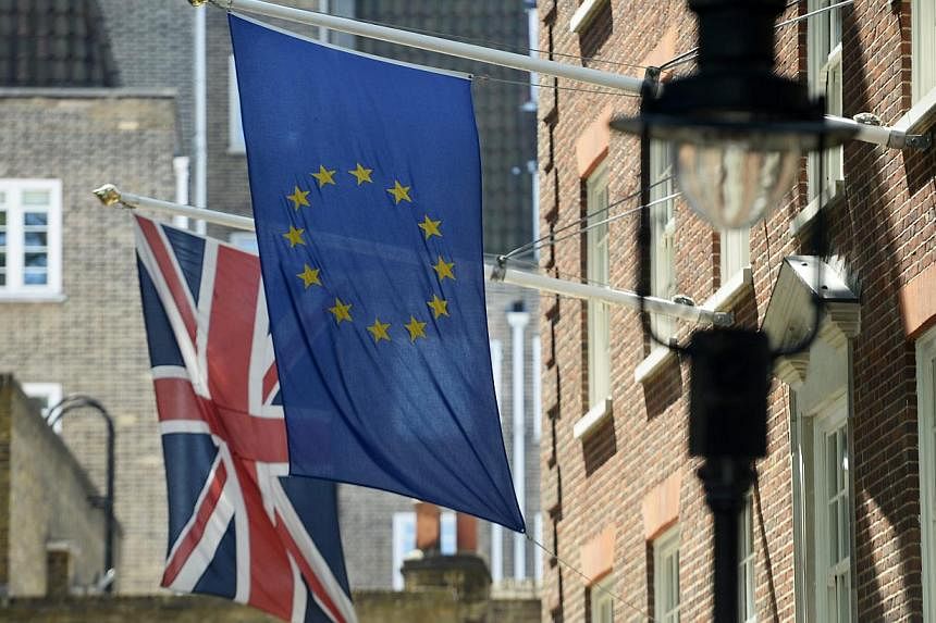 The Union Flag (left) next to the EU flag (right) near Westminster in London, Britain, on May 26, 2015.&nbsp;Voters will be asked "Should the United Kingdom remain a member of the European Union?" in a referendum to be held by 2017, the British gover