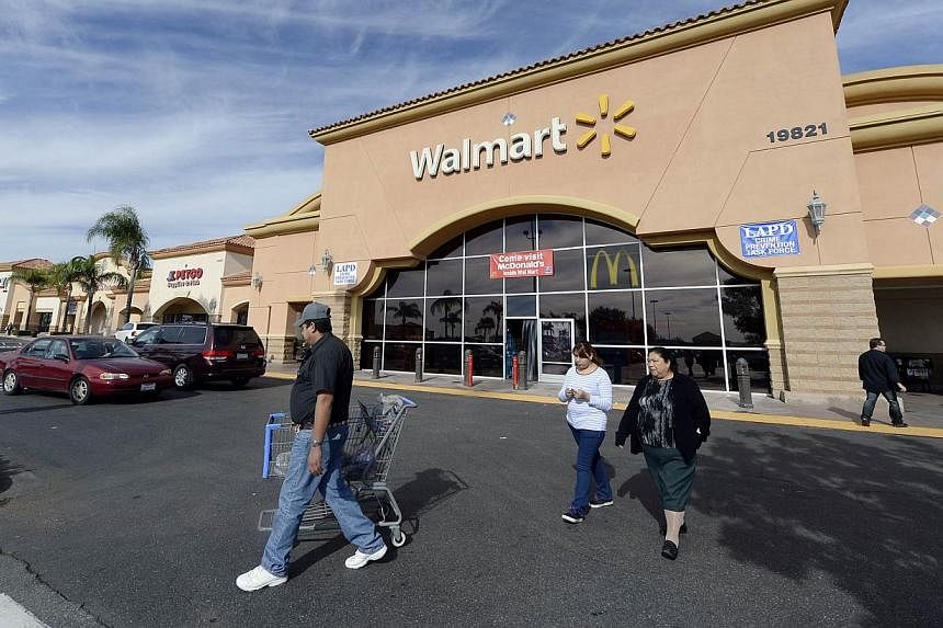 Customers walking outside a Walmart store in the Porter Ranch section of Los Angeles on Nov 26, 2013. -- PHOTO: REUTERS