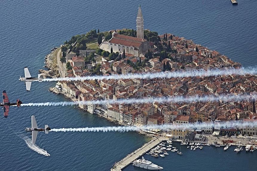 Planes flying in formation over the city of Rovinj during the Red Bull Air Race World Championship in &nbsp;Croatia. -- PHOTO: EPA