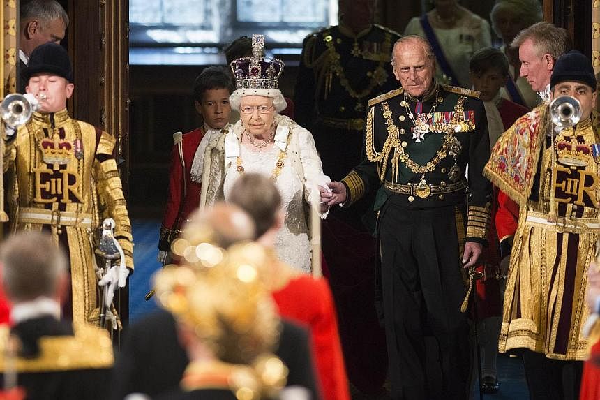 Britain's Queen Elizabeth II (second, left) accompanied by Prince Philip, Duke of Edinburgh (third, right) entering the Royal Gallery during the State Opening of Parliament at the Palace of Westminster in central London on May 27, 2015. -- PHOTO: AFP