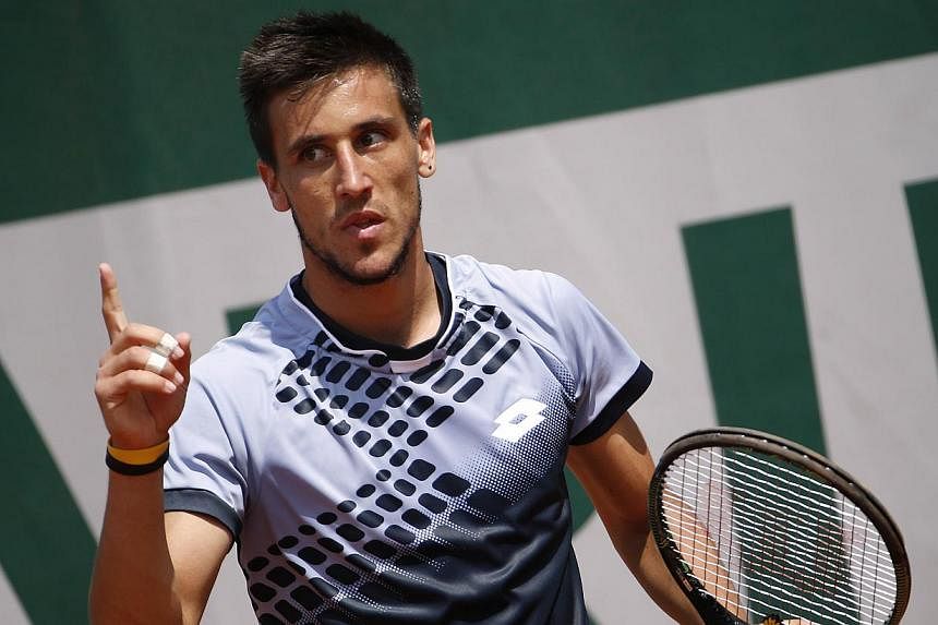 Bosnia-Herzegovina's Damir Dzumhur celebrating after winning a point against Cyprus' Marcos Baghdatis during the men's second round of the Roland Garros 2015 French Tennis Open in Paris on May 27, 2015. -- PHOTO: AFP