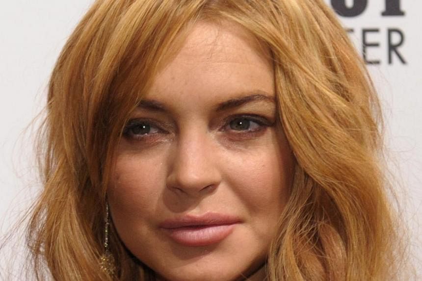 This February 6, 2013 file photograph shows Lindsay Lohan at the amfAR (The Foundation for AIDS Research) gala in New York. -- PHOTO: AFP