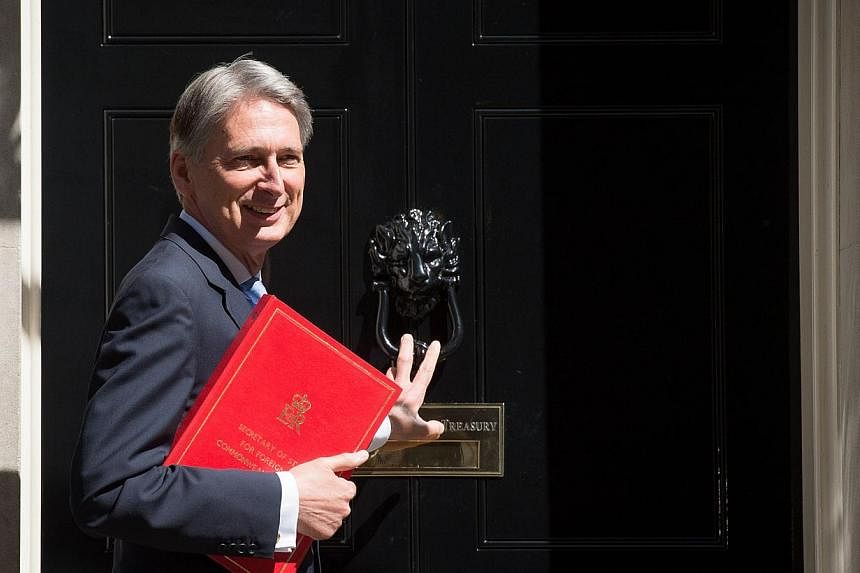 British Foreign Secretary Philip Hammond arrives for the first weekly cabinet meeting in Downing Street, central London, on May 12, 2015, following the May 7 general election. -- PHOTO: AFP