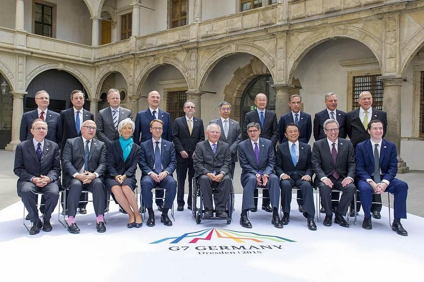 G7 finance ministers and governors pose for a family photo during the G7 summit at the Palace Residenzschloss in Dresden, eastern Germany, on May 28, 2015. -- PHOTO: AFP