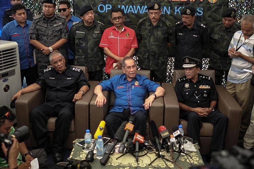 Malaysia's Deputy Home Minister Wan Junaidi Tuanku Jaafar (centre) speaks during a press conference after the government announced the discovery of camps and graves,near the Malaysia-Thailand border in Wang Kelian, on May 28, 2015. -- PHOTO: AFP