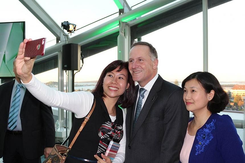 New Zealand Prime Minister John Key (centre) taking a selfie with Vietnamese journalists at a gathering of Asean media in Auckland, as part of events marking the 40th anniversary of ties between the region and New Zealand, at the Auckland War Memoria