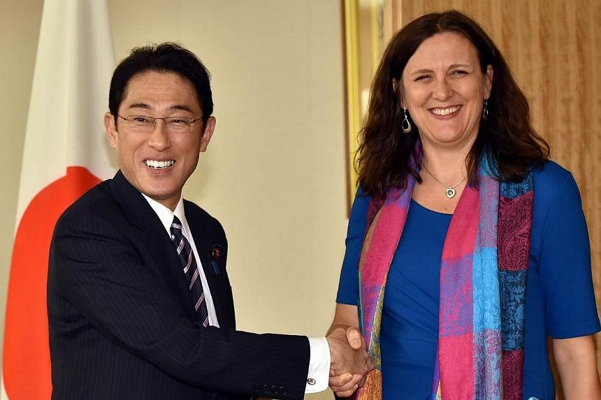 European Commissioner for Trade Cecilia Malmstrom (right) shakes hands with Japanese Foreign Minister Fumio Kishida prior to their talks in Tokyo on May 27, 2015.&nbsp;Ms Malmstrom on Thursday called on Japan to accelerate negotiations on tariffs and