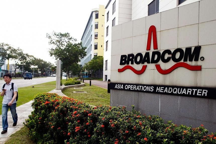 A man passes Broadcom's Asia operations headquarters office at an industrial park in Singapore. -- PHOTO: REUTERS