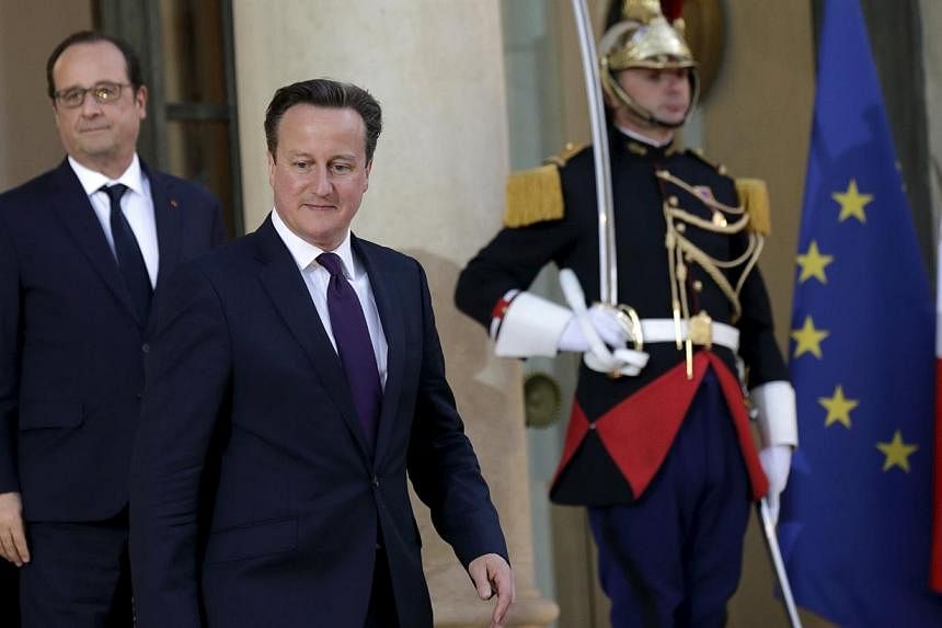French President Francois Hollande (left) accompanying Britain's Prime Minister David Cameron as he leaves the Elysee Palace after a meeting in Paris, France, on May 28, 2015. -- PHOTO: REUTERS