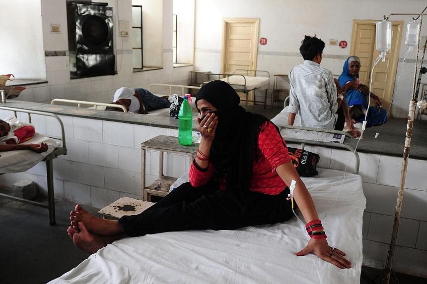 Patient Nansi Bano gesturing as she sits on a bed in a government hospital in Allahabad on May 28, 2015, as scorching weather conditions continue across India. -- PHOTO: AFP