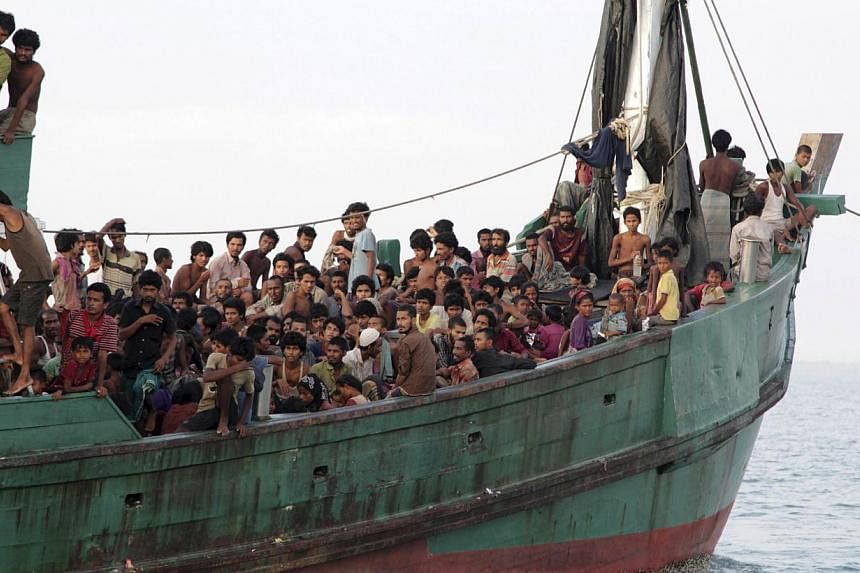 Rohingya and Bangleshi migrants waiting on board a fishing boat before being transported to shore, off the coast of Julok, in Aceh province on May 20, 2015, in this photo taken by Antara Foto. -- PHOTO: REUTERS