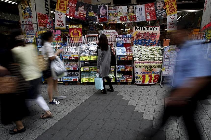 A woman looking at items outside a discount drug store in Tokyo, Japan, on May 28, 2015. -- PHOTO: REUTERS