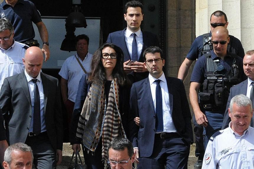 Francoise Bettencourt-Meyers (centre), daughter of France's richest woman Liliane Bettencourt, flanked by her sons Nicolas (at her left) and Jean-Victor (centre,background), leaves on May 28, 2015, the Bordeaux courthouse, south-western France, after