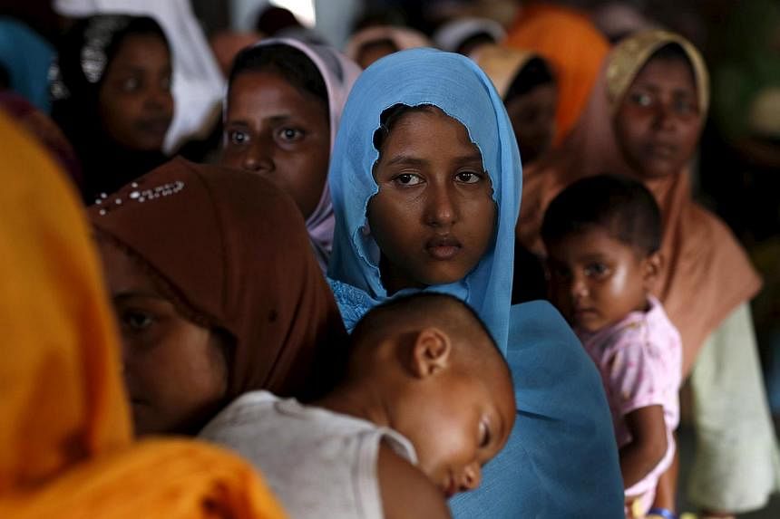 Rohingya migrants who arrived in Indonesia last week by boat wait in line to receive donations at a temporary shelter in Aceh Timur regency, near Langsa in Indonesia's Aceh Province on May 25, 2015. -- PHOTO: REUTERS