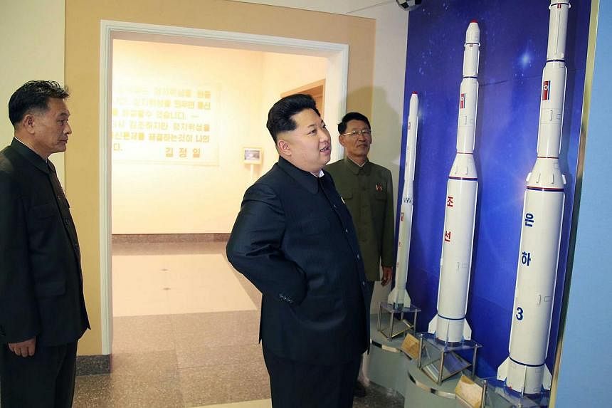 This undated picture released by North Korea's official Korean Central News Agency (KCNA) on May 3, 2015, shows North Korean leader Kim Jong Un (centre) inspecting the newly-built General Satellite Control and Command Centre of the National Aerospace
