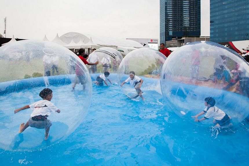 Children can play in zorb balls in the pool at the pop-up urban beach. -- PHOTO: DBS