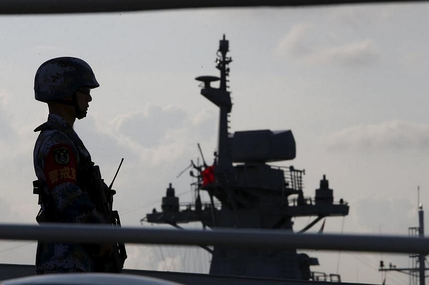 A member of the People's Liberation Army navy standing guard on a Chinese vessel. China's White Paper released on Tuesday paints a new and expansive view of the country's maritime power, while signalling a shake-up of some traditional combat structur
