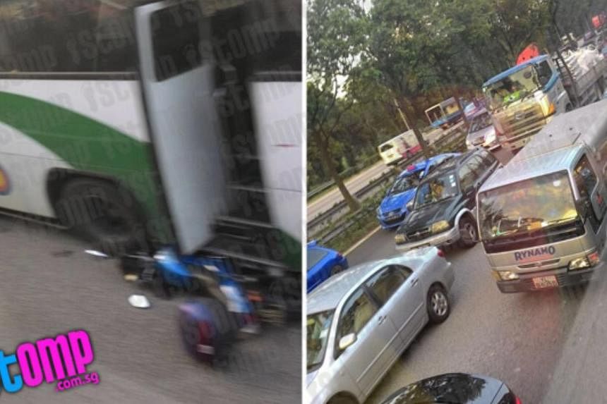 A motorcycle was crushed under a bus in an accident involving a motorcycle, a bus and a lorry on the AYE on Friday morning. -- PHOTO: STOMP