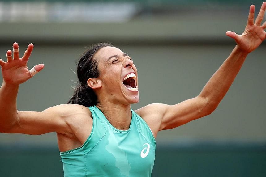 Francesca Schiavone of Italy celebrating after winning the second round match. -- PHOTO: EPA