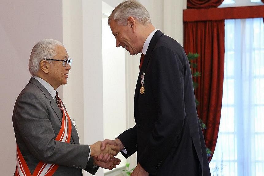President Tony Tan Keng Yam presenting the Public Service Star (Distinguished Friends of Singapore) award to Mr Dominic Barton, global managing director at McKinsey &amp; Company, at the Istana. -- PHOTO: MINISTRY OF COMMUNICATIONS AND INFORMATION&nb