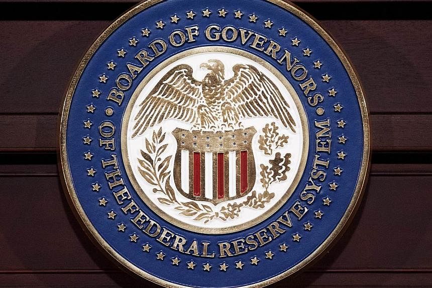This June 19, 2013 file photo shows the seal of the Federal Reserve Board of Governors in Washington, DC. The world's largest economy hit a bigger ditch in the first quarter than initially estimated, held back by harsh winter weather, a strong dollar
