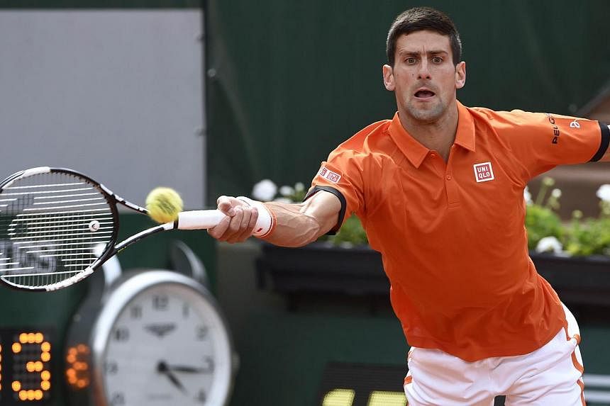 Serbia's Novak Djokovic returns the ball to Luxemburg's Gilles Muller during the men's second round at the Roland Garros 2015 French Tennis Open in Paris on May 28, 2015. -- PHOTO: AFP