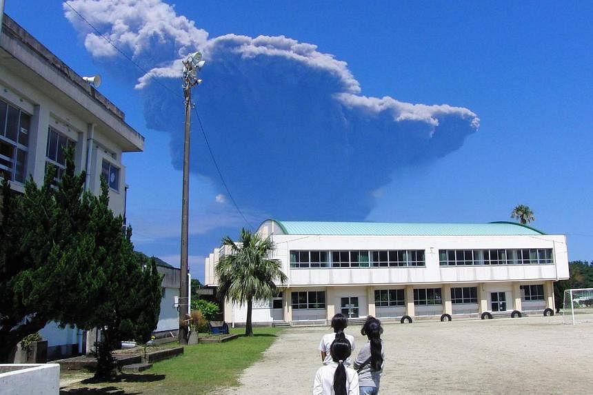 A handout photo released by the Nagata Elementary School shows schoolchildren at Nagata Elementary School on Yakushima Island looking towards volcanic ash rising from Mount Shindake on Kuchinoerabujima&nbsp;island, about 12 km west of UNESCO's World 