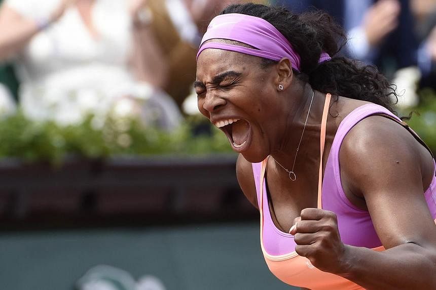 US player Serena Williams celebrating after winning her match against Germany's Anna-Lena Friedsam during the women's second round of the Roland Garros 2015 French Tennis Open in Paris on May 28, 2015. Williams won the match 5-7, 6-3, 6-3. -- PHOTO: 