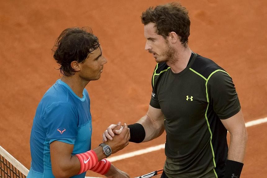 Rafael Nadal (left) shake hands to Scottish tennis player Andy Murray at the end of the men final of Madrid Open tournament at the Caja Magica (Magic Box) sports complex in Madrid on May 10, 2015. Murray won 6-3, 6-2. -- PHOTO: AFP&nbsp;