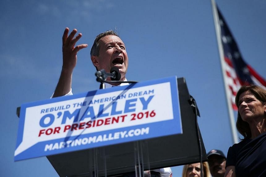 Former Maryland Governor Martin O'Malley (left) speaks as his wife Katie looks on during an event to announce his candidacy for a presidential campaign on May 30, 2015 at Federal Hill Park in Baltimore, Maryland. -- PHOTO: AFP&nbsp;
