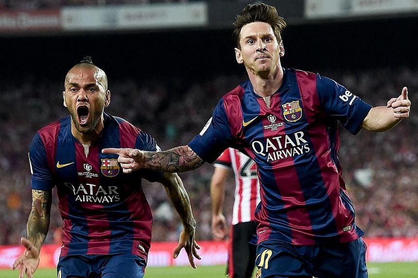 Barcelona's Lionel Messi (right) celebrating a goal along with teammate Dani Alves as the Catalans triumphed 3-1 in the King's Cup final at Camp Nou, Barcelona, on May 30, 2015. -- PHOTO: AFP
