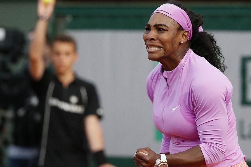 Serena Williams celebrates after winning a point against Belarus' Victoria Azarenka during the women's third round at the Roland Garros 2015 French Tennis Open in Paris on May 30, 2015. -- PHOTO: AFP&nbsp;