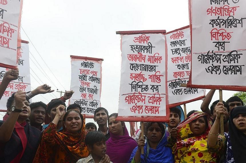 Memebers of Bangladeshi garments worker union shout slogans as they mark the second anniversary of the Rana Plaza building collapse at the site where the building once stood in Savar, on the outskirts of Dhaka on April 24, 2015. Bangladesh police sai