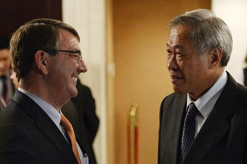 Singapore Defence Minister Ng Eng Hen (right) with US Secretary of Defence Ashton Carter during the ministerial luncheon yesterday. Dr Carter spoke at the Shangri-La Dialogue as Pentagon chief for the first time.