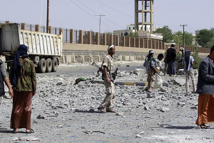 Huthi Shi'ite militants inspect damage following an air-strike by the Saudi-led coalition in Al-Thawra sport city, located north of the capital Sanaa on May 31, 2015. Several Americans have been detained in Yemen, a State Department official said Sun