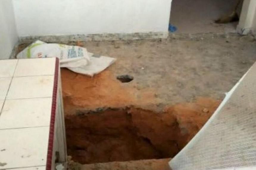 The body of a child was found buried in cement in the kitchen floor of a house in Taman Usaha Jaya, Kepong, on Friday, May 29, 2015. -- PHOTO: THE STAR/ASIA NEWS NETWORK&nbsp;