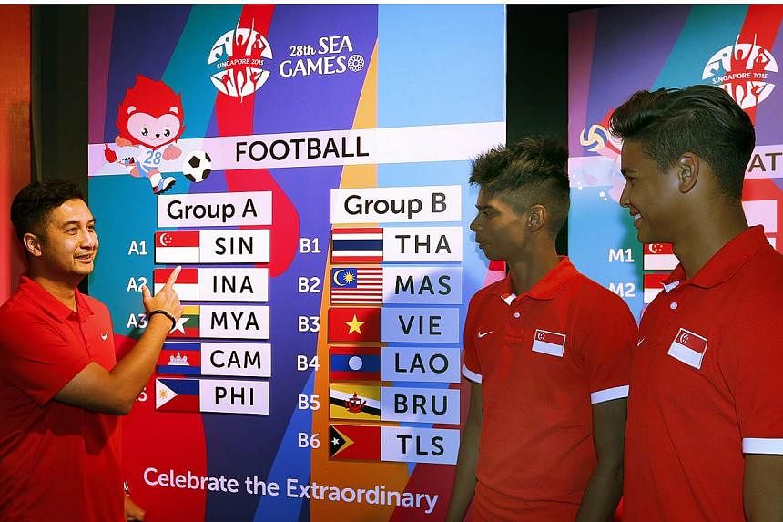 (From left) National Under-23 coach Aide Iskandar with players Iqbal Hussain and Irfan Fandi examining the draw conducted on April 15, 2015 for the June SEA Games.&nbsp;Aide has issued a warning to his charges, reminding them not to underestimate the
