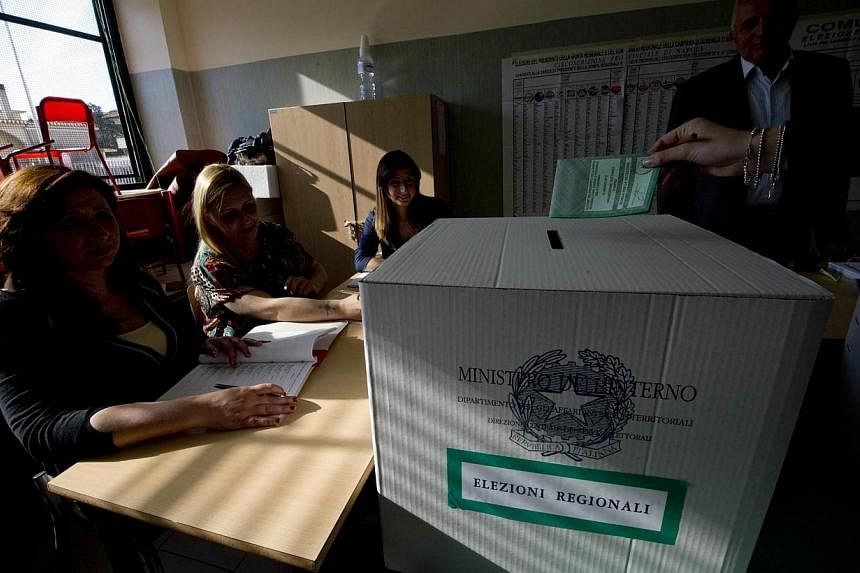 A person casts a vote during regional and municipal elections, at a polling station in Giugliano, near Naples, Italy, on May 31, 2015.&nbsp;Italians voted Sunday in regional elections seen as a key measure of the fading fortunes of ex-premier Silvio 