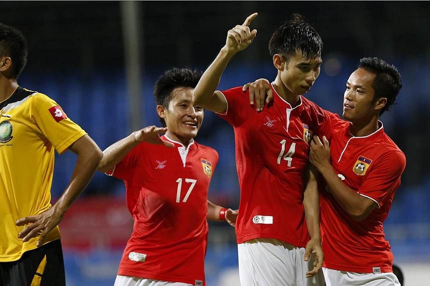 Laos' Soukchinda Natphasouk (second from right) celebrates with his teammates after scoring his team's second goal against Brunei in the 28th SEA Games men's football first round group B match at the Bishan Stadium on 31 May 2015. --&nbsp;ST PHOTO: K
