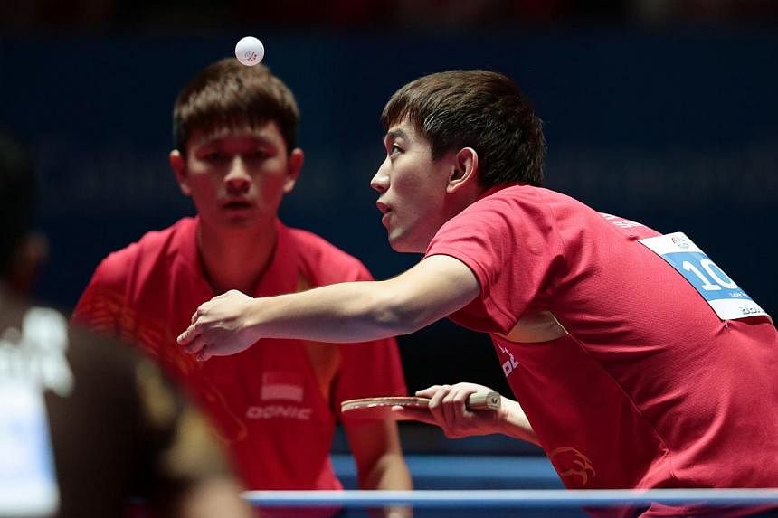 Singapore's Chen Feng (right) and Chew Zhe Yu Clarence in action at the SEA Games 2015. The Republic paddlers are on course for all-Singapore finals in both the SEA Games men's and women's doubles competitions, as all four pairings progressed into se