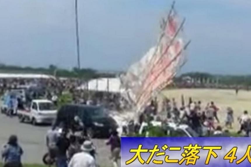 A giant kite weighing three-quarters of a tonne crashed into a crowd of spectators in Japan at the weekend, an official said on Monday, hurting four people including an elderly man. -- PHOTO: SCREENGRAB FROM YOUTUBE&nbsp;