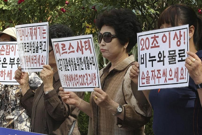 Members of a civic group on public health rally in front of the state-run National Health Insurance Service in Seoul, South Korea, on June 1, 2015, to urge the government to release information on places of residence related to patients infected with