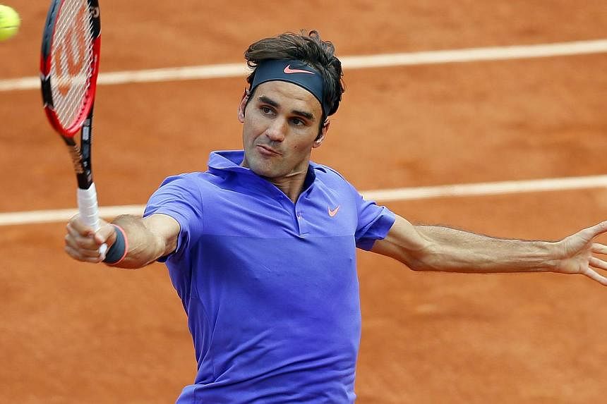 Roger Federer of Switzerland in action against Gael Monfils of France during their fourth round match for the French Open tennis tournament at Roland Garros in Paris, France on June 1, 2015. -- PHOTO: EPA