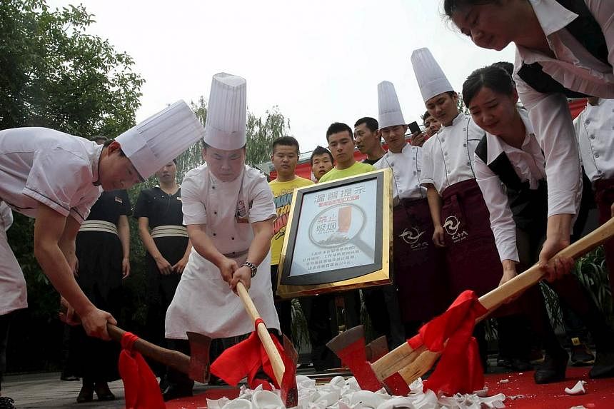 Restaurant staff axe ashtrays as Beijing started new anti-smoking curb, China, on June 1, 2015.&nbsp;China's capital city was sprinkled with red-uniformed volunteers, propaganda banners and no-smoking signs on Monday as Beijing unrolled ambitious new