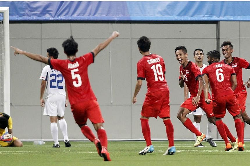 Singapore's Sheikh Abdul Hadi (fourth right) celebrates after scoring the match's only goal. -- PHOTO: REUTERS