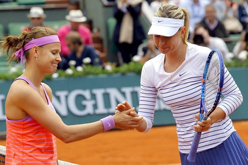 Lucie Safarova of Czech Republilc (left) shakes hands after winning against Maria Sharapova of Russia during their fourth round match for the French Open tennis tournament at Roland Garros in Paris, France on June 1, 2015. -- PHOTO: EPA